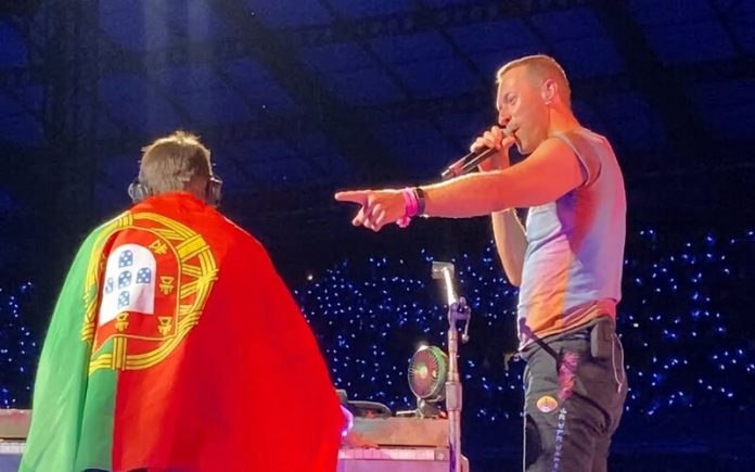 Jovem fã realiza sonho de tocar piano em concerto dos Coldplay