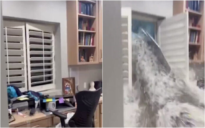 Moradora regista momento em que inundação rompe a janela da sua casa