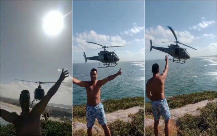 Helicóptero da Polícia Militar posa para turistas em praia de Laguna