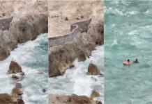 Menino resgatado após ficar preso em rocha no meio do mar