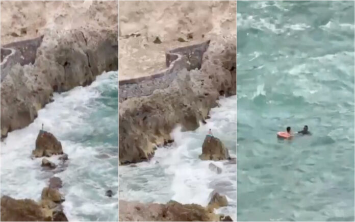 Menino resgatado após ficar preso em rocha no meio do mar