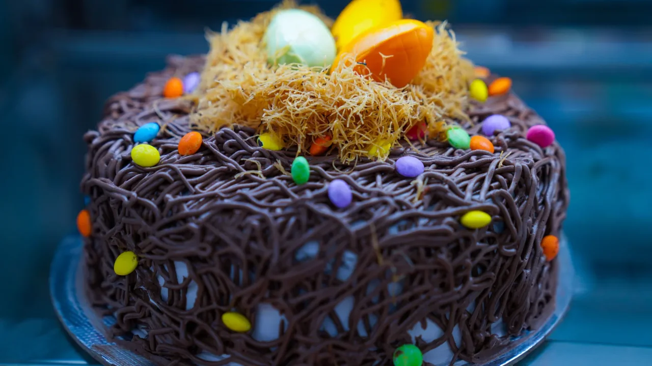 Illustrative photograph. It does not confirm the identity of any person mentioned in the article. Vibrant chocolate cake topped with colorful eggs and candy, perfect for Easter celebrations.