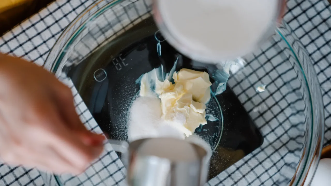Illustrative photograph. It does not confirm the identity of any person mentioned in the article. Hands measuring sugar and butter in a bowl for a recipe. Perfect for baking enthusiasts.